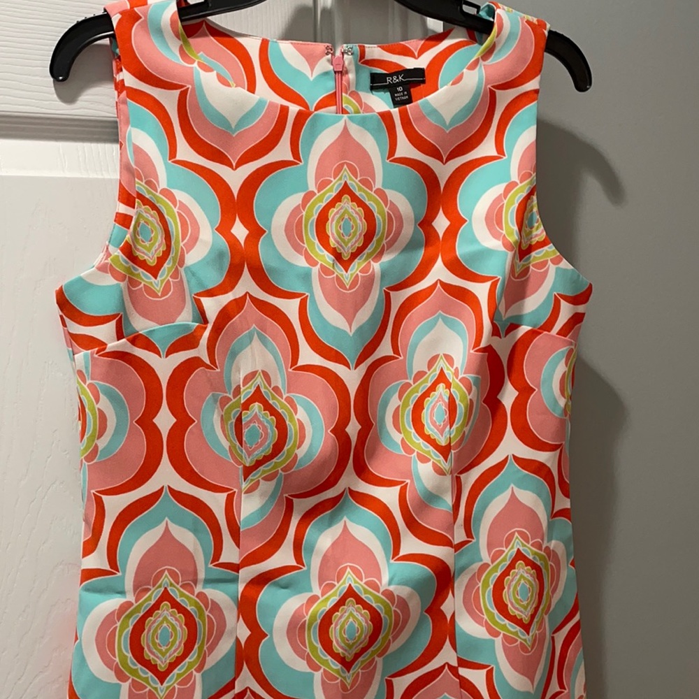 Sleeveless aqua, pink, orange dress.